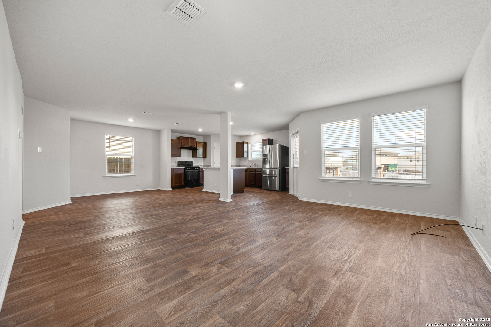 208 Greater Scaup San Antonio, TX 78253 - Photo 5 of 18 an empty room with wooden floor and windows