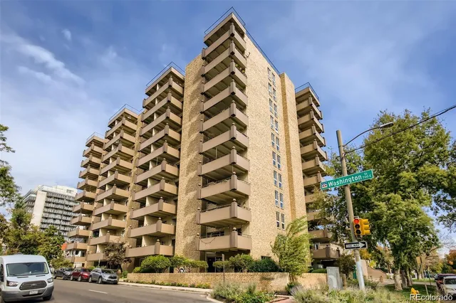 a view of a kitchen with a refrigerator and a stove top oven