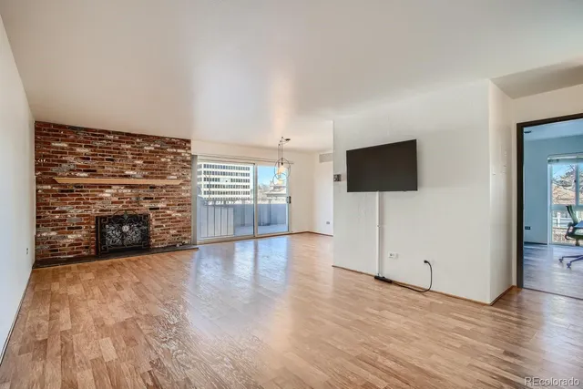 a view of a kitchen with wooden floor and cabinets