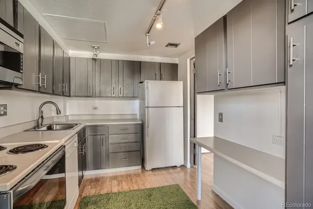a kitchen with a sink stove and microwave