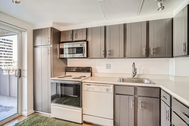 a view of a livingroom with a ceiling fan window and wooden floor