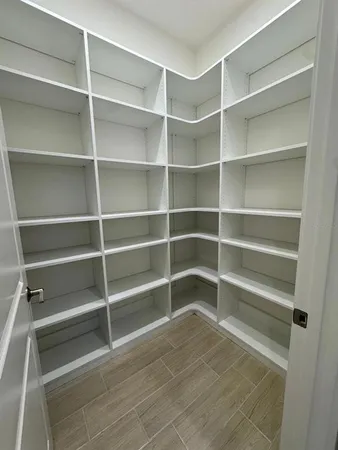 a view of walk in closet with empty racks