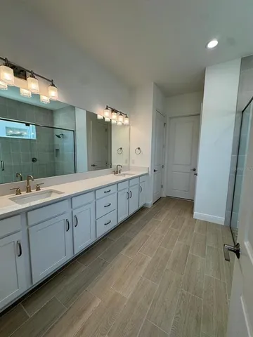a bathroom with a double vanity sink and mirror