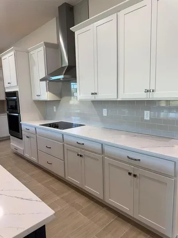 a kitchen with white cabinets and white appliances