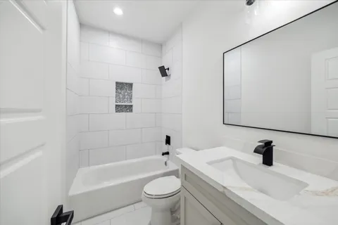a bathroom with a sink a toilet and a bathtub