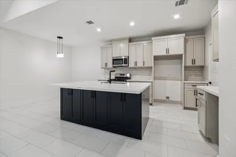 a kitchen with a sink cabinets and stainless steel appliances