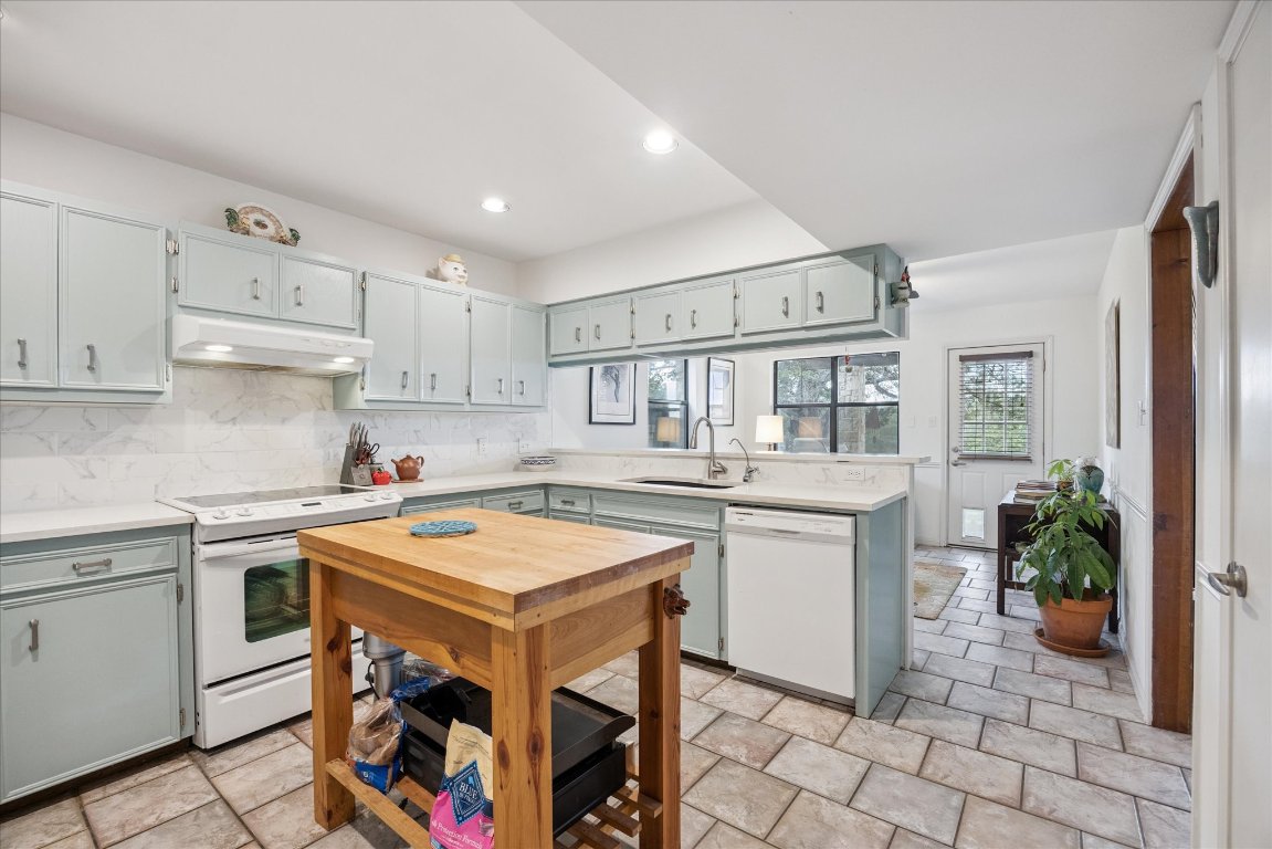 7806 Comanche Trail Leander, TX 78641 - Photo 12 of 32 a kitchen with a stove a sink and a refrigerator