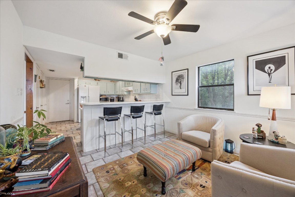 7806 Comanche Trail Leander, TX 78641 - Photo 14 of 32 a living room with furniture a rug and a chandelier