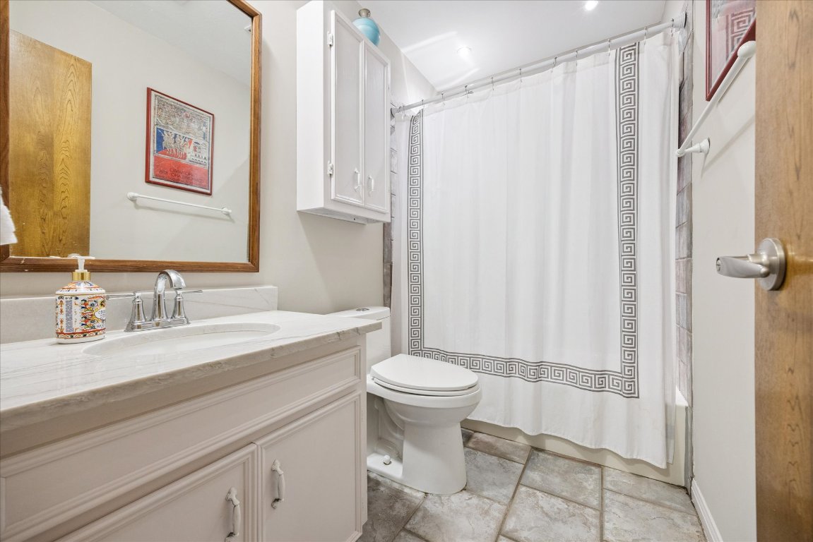 7806 Comanche Trail Leander, TX 78641 - Photo 17 of 32 a bathroom with a sink a toilet and shower