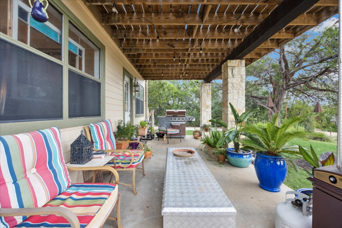 7806 Comanche Trail Leander, TX 78641 - Photo 27 of 32 a living room with patio furniture and potted plants
