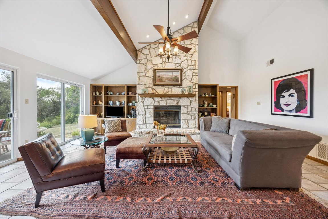 7806 Comanche Trail Leander, TX 78641 - Photo 9 of 32 a living room with fireplace furniture and a chandelier