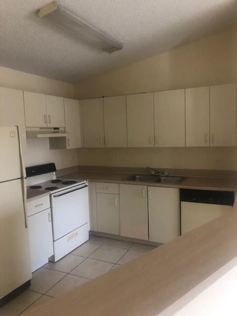 Playland Hollywood, FL 33021 - Photo 3 of 10 a kitchen with granite countertop white cabinets and white appliances
