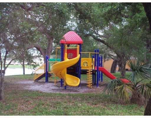 Playland Hollywood, FL 33021 - Photo 8 of 10 a backyard of a house with barbeque oven table and chairs