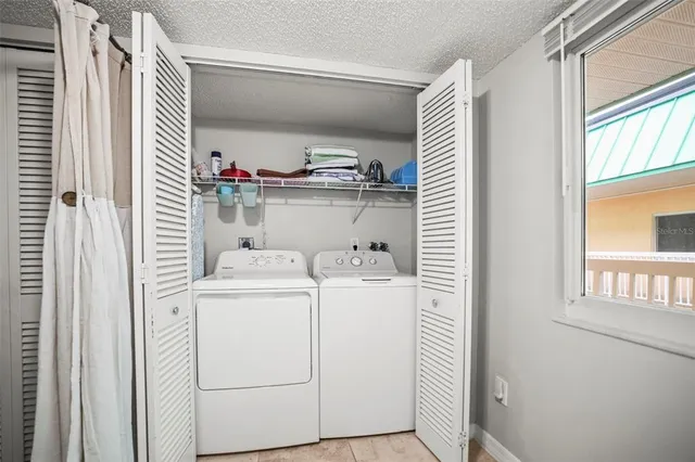a view of a refrigerator in kitchen and entryway