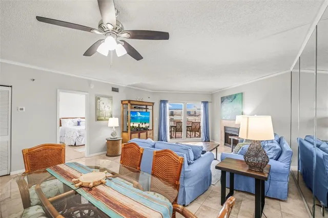a living room with furniture kitchen view and a large window
