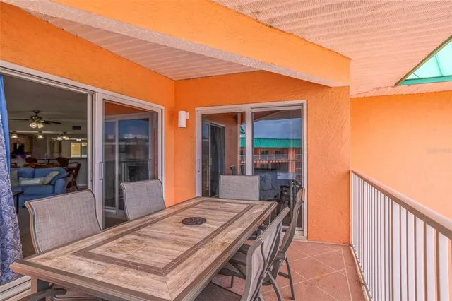 a bedroom with a bed large window with table and chair