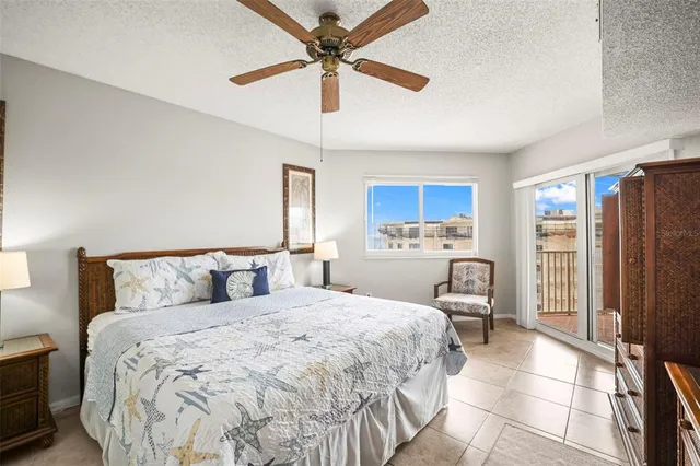 a bedroom with a bed dresser and a flat tv screen