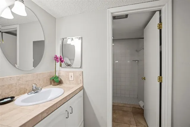 a bathroom with a shower a toilet and a sink