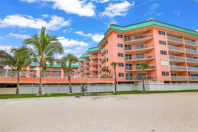 a row of palm trees and building in the background