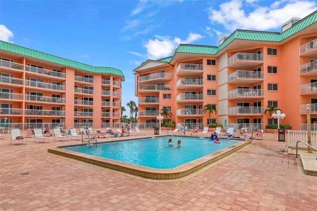 a view of a swimming pool with a table and chairs