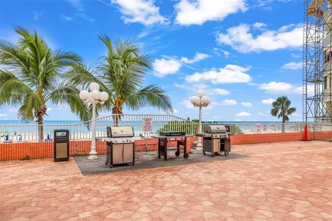 a view of a balcony with a barbeque