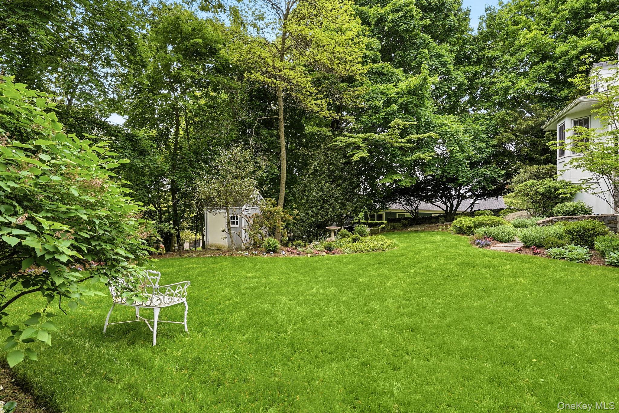 26 Cedarlawn Road Irvington, NY 10533 - Photo 30 of 34 a garden with trees in front of it