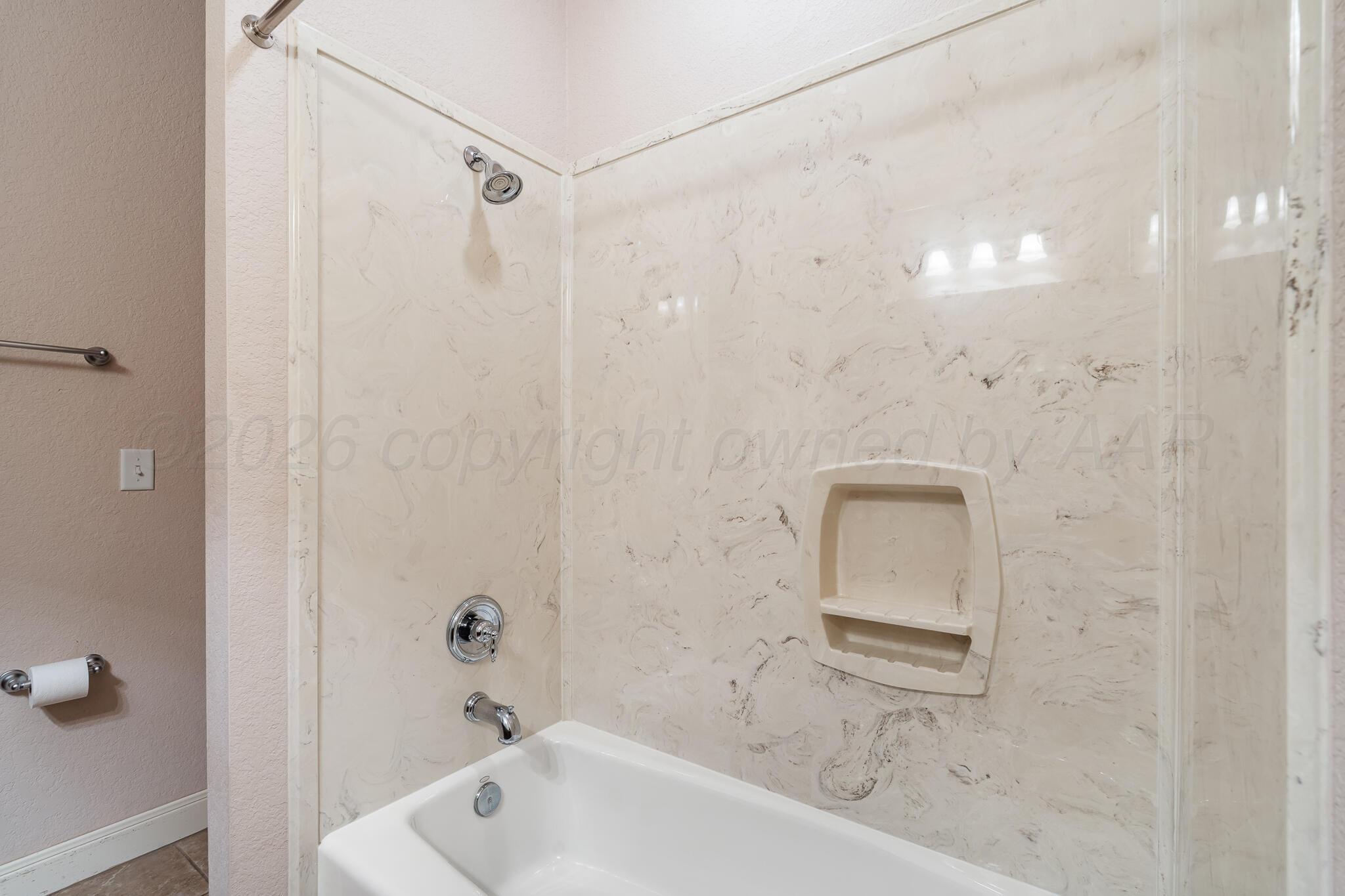 5008 Wesley Road Amarillo, TX 79119 - Photo 34 of 47 a bathroom with a bathtub