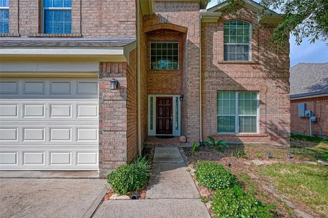 front view of a brick house with a large windows