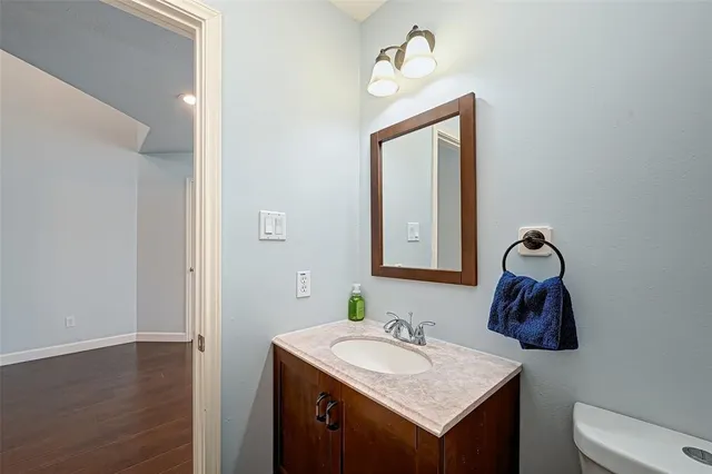 a view of wooden floor and a chandelier fan in a room