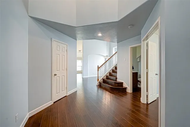 a house that is sitting in the grass with tress in front of it