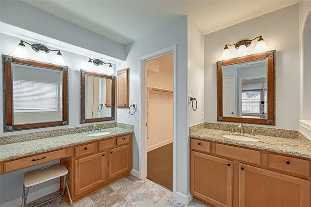 a bathroom with a granite countertop sink mirror and