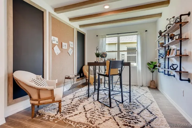 a view of a dining room with furniture and a window