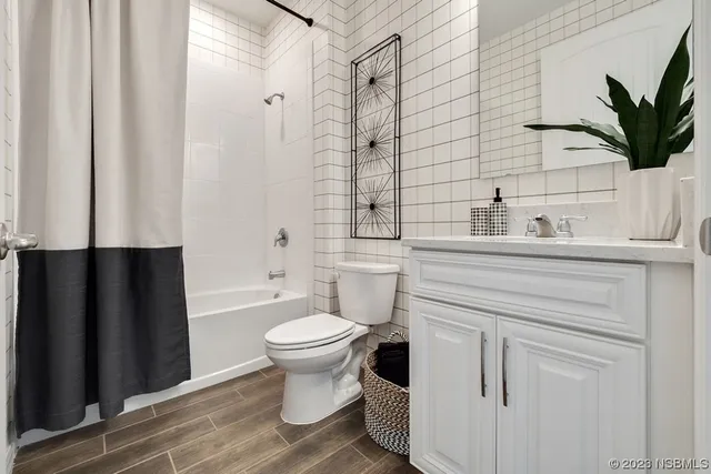 a bathroom with a sink toilet a mirror and shower