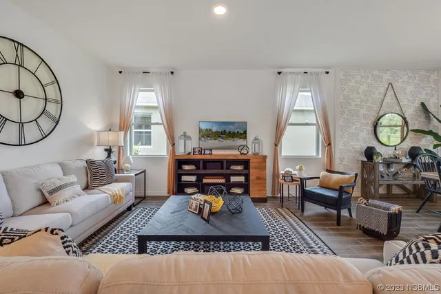 a living room with furniture a rug and a large window