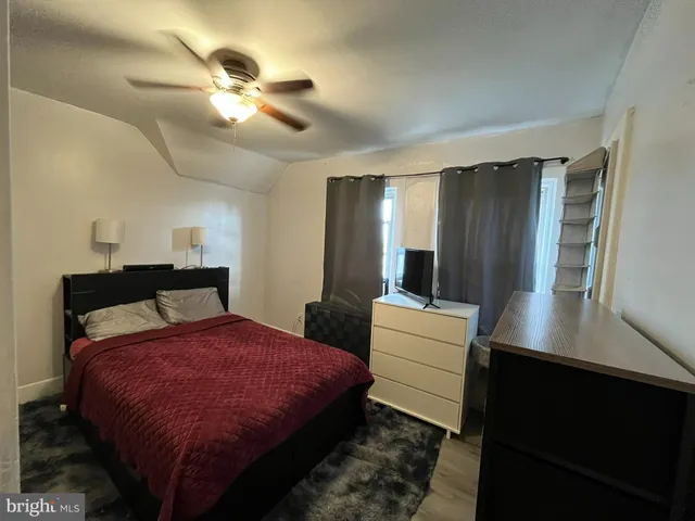 a bed room with a bed and a television