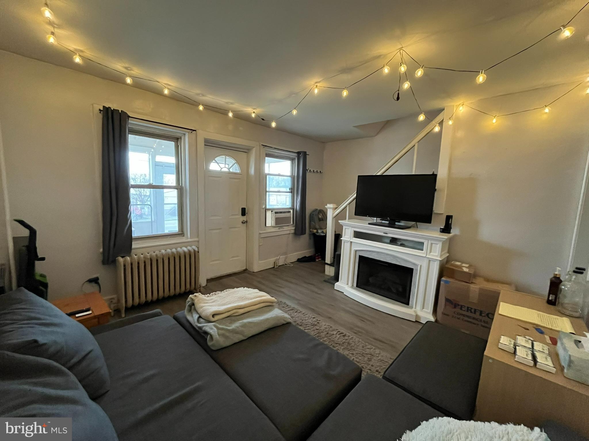 227 Ridge Road Claymont, DE 19703 - Photo 6 of 18 a living room with furniture a flat screen tv and a fireplace