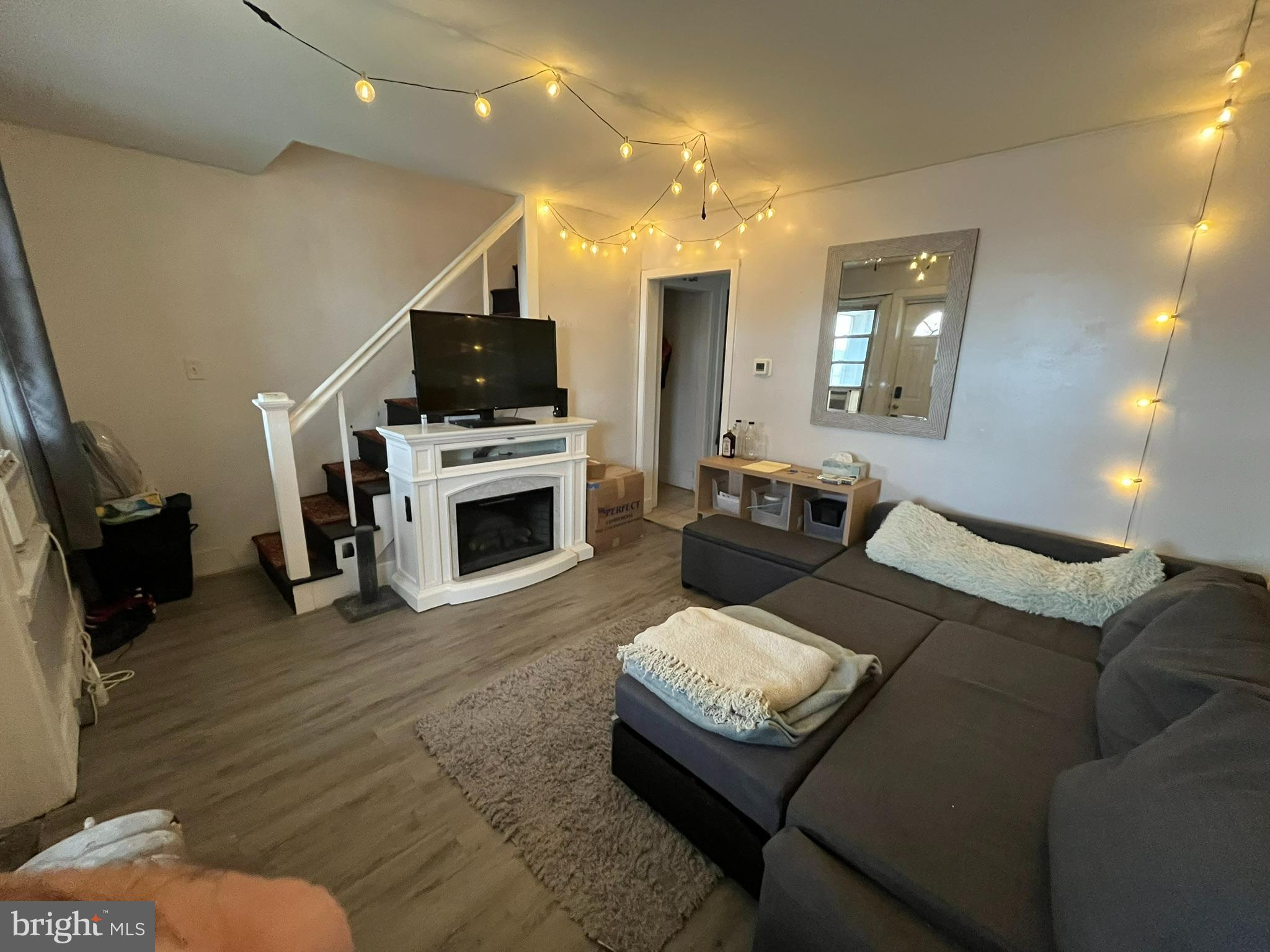 227 Ridge Road Claymont, DE 19703 - Photo 7 of 18 a living room with furniture a flat screen tv and a fireplace