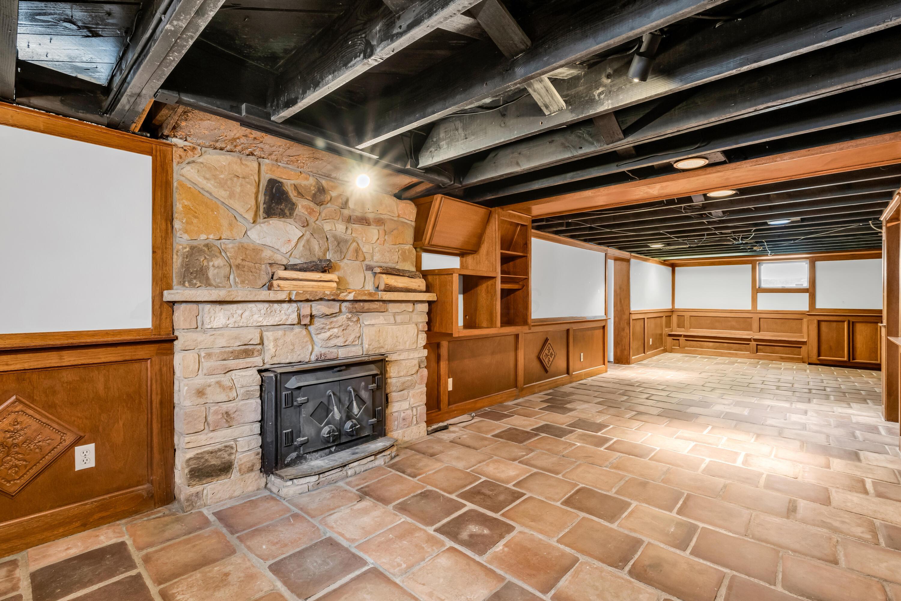 2033 Zollinger Road Columbus, OH 43221 - Photo 28 of 44 • Ceramic tile flooring
• Ivory painted & wainscoted
walls
• Built-in seating & storage
• Can lighting
• Lighted cedar closet
• Stone fireplace with
woodburning insert
• Built-in bookcases
• Water meter access