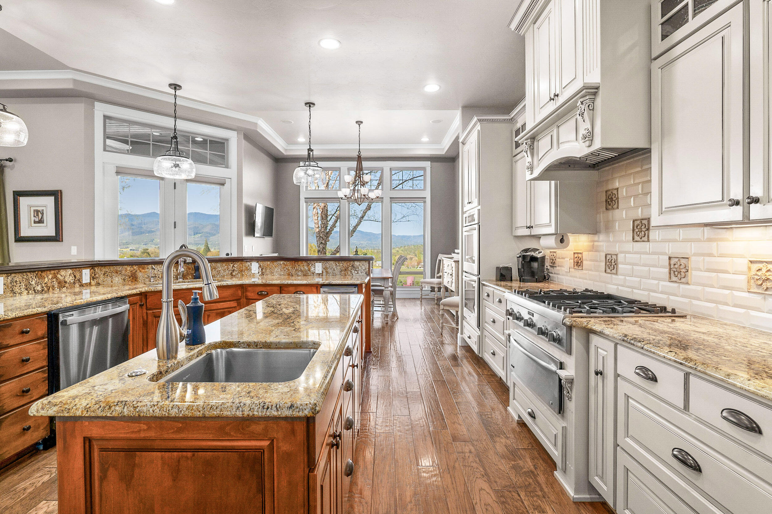 5709 Hughes Road Medford, OR 97504 - Photo 17 of 70 a kitchen with stainless steel appliances granite countertop wooden cabinets sink and stove