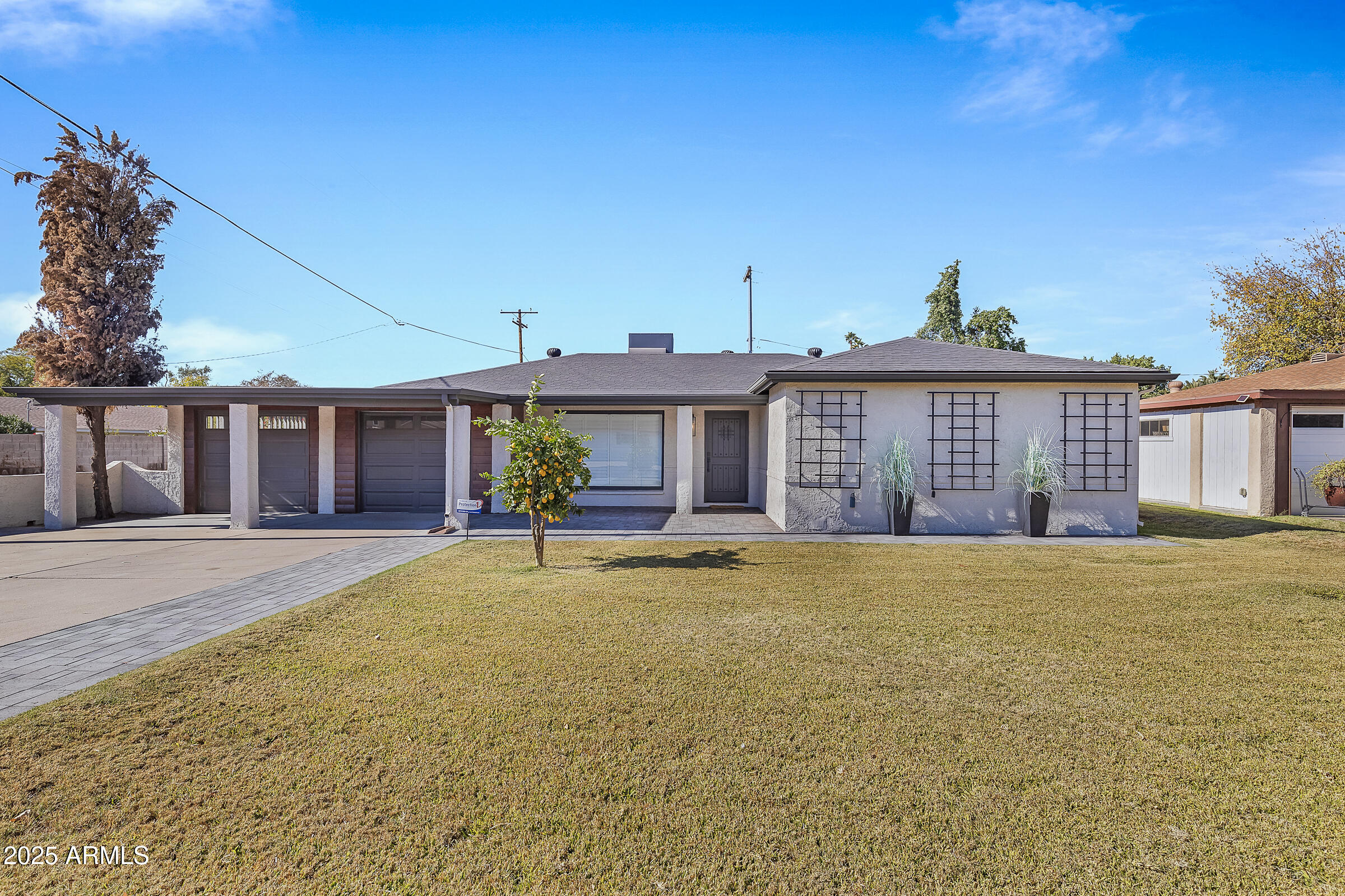 7308 North 7th Avenue Phoenix, AZ 85021 - Photo 1 of 42 a front view of a house with a yard and garage
