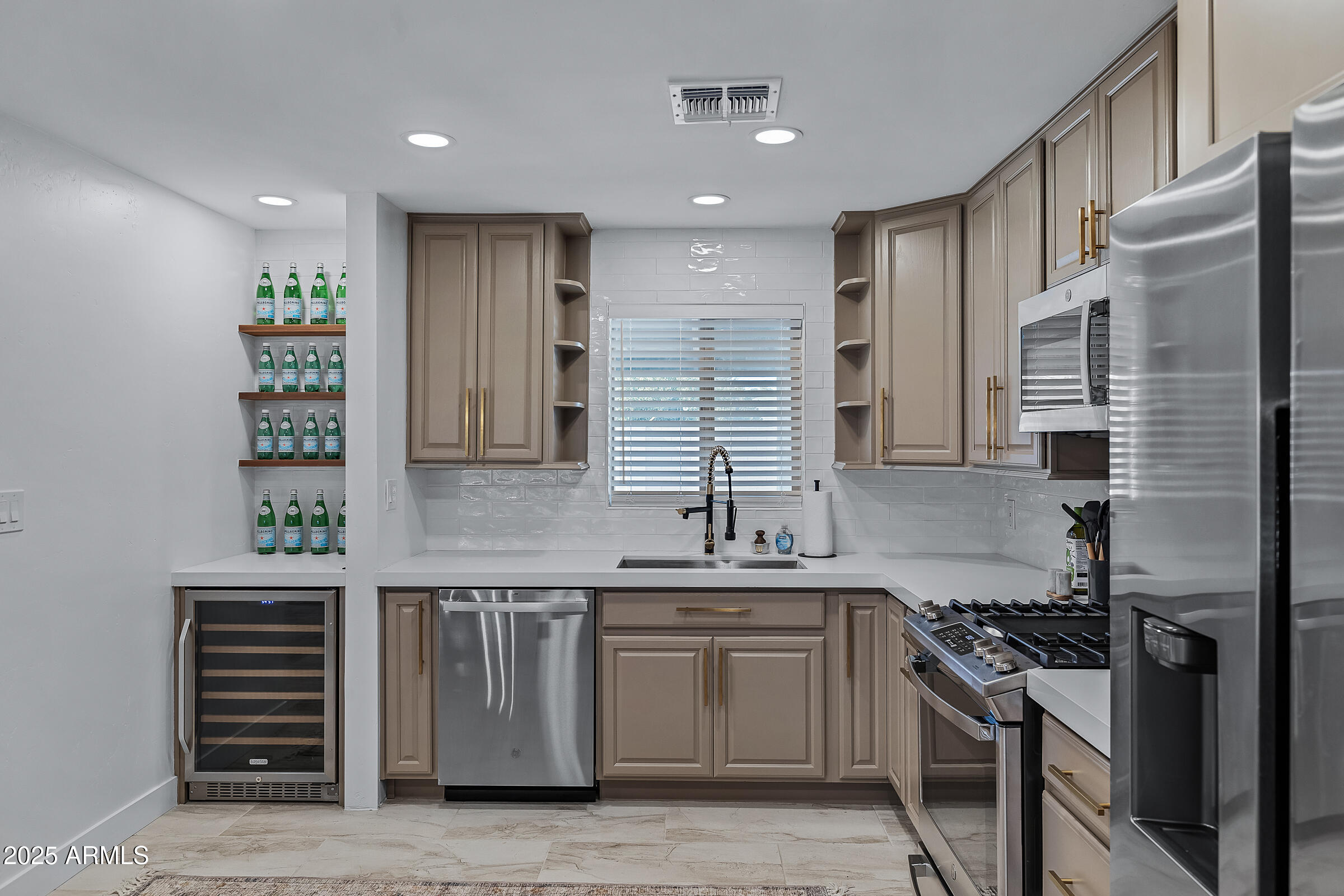 7308 North 7th Avenue Phoenix, AZ 85021 - Photo 12 of 42 a kitchen with stainless steel appliances granite countertop a sink stove and cabinets