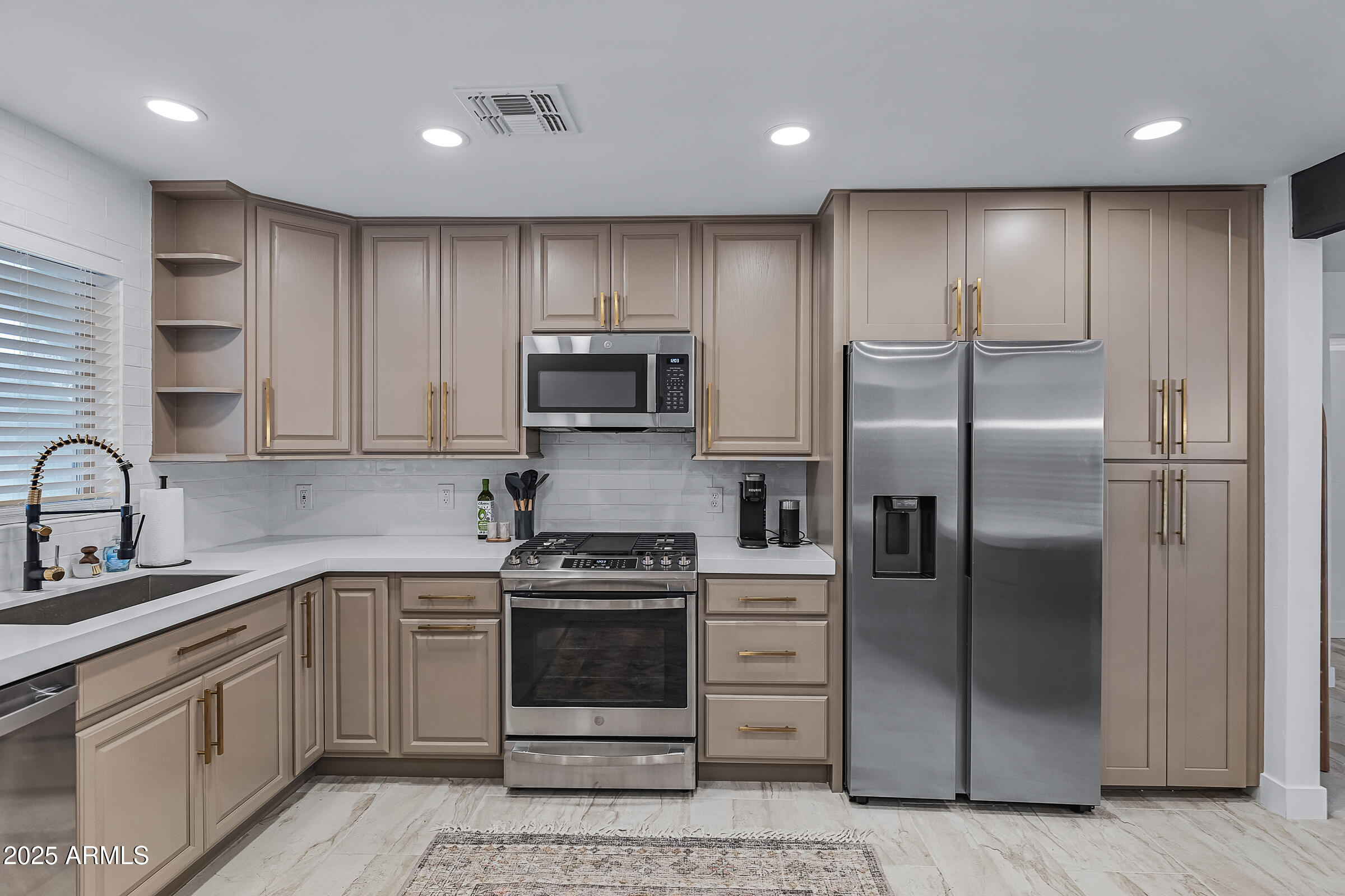 7308 North 7th Avenue Phoenix, AZ 85021 - Photo 14 of 42 a kitchen with a sink stainless steel appliances and cabinets