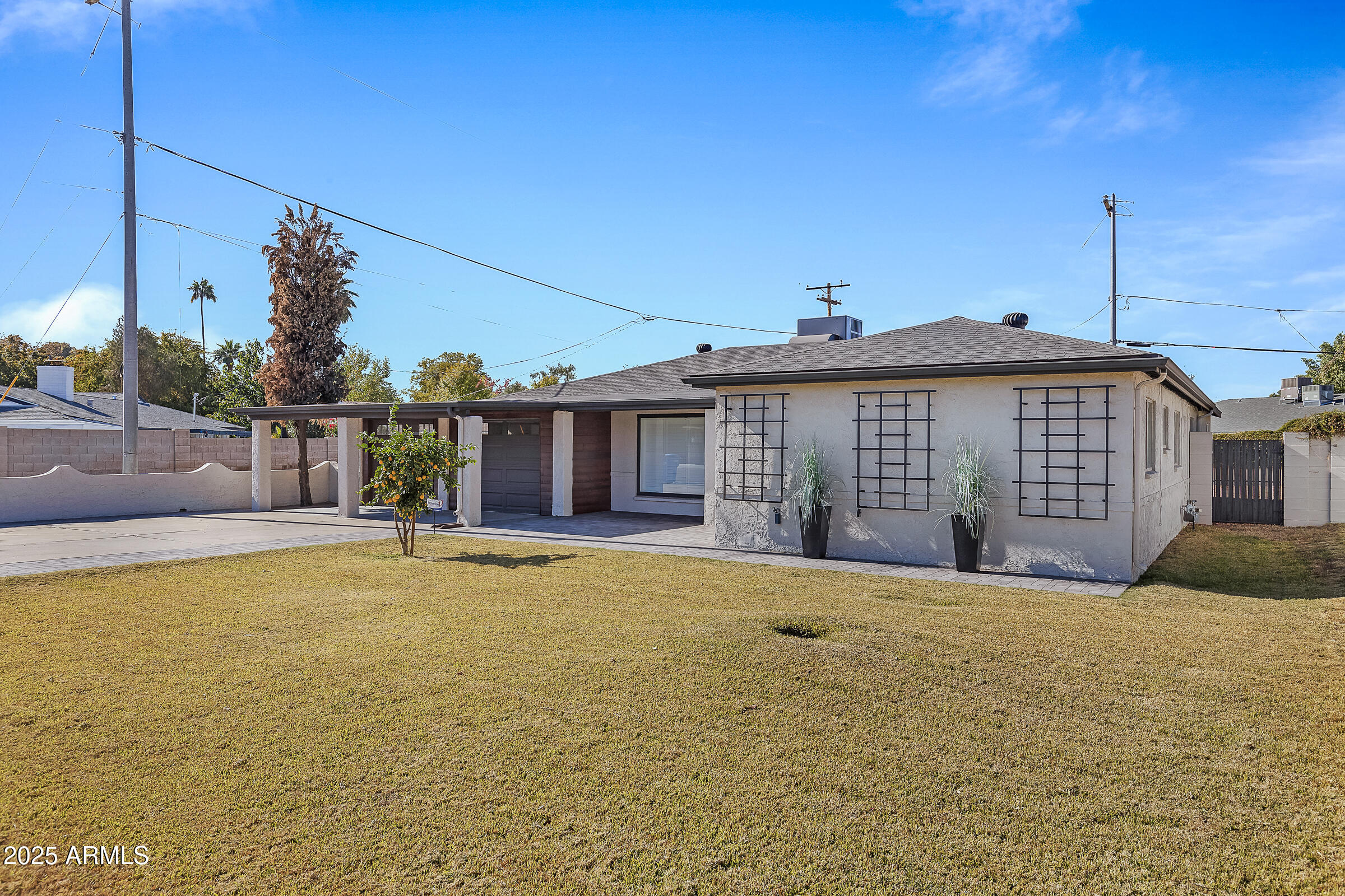 7308 North 7th Avenue Phoenix, AZ 85021 - Photo 2 of 42 a front view of a house with a garden and yard