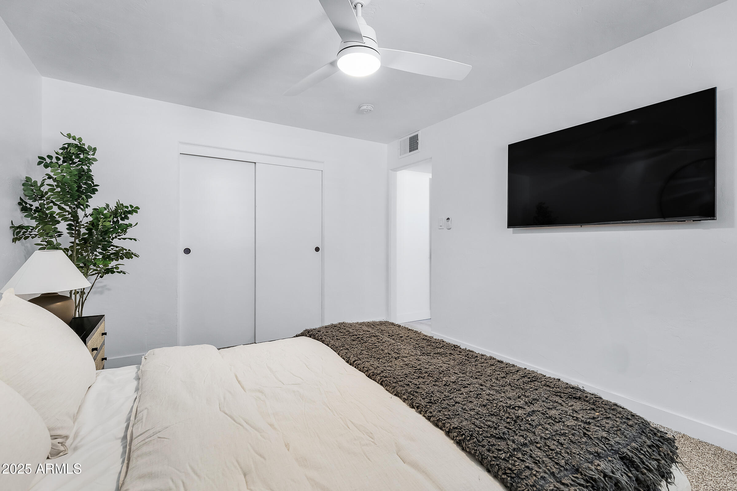 7308 North 7th Avenue Phoenix, AZ 85021 - Photo 24 of 42 a bedroom with a bed and a flat screen tv