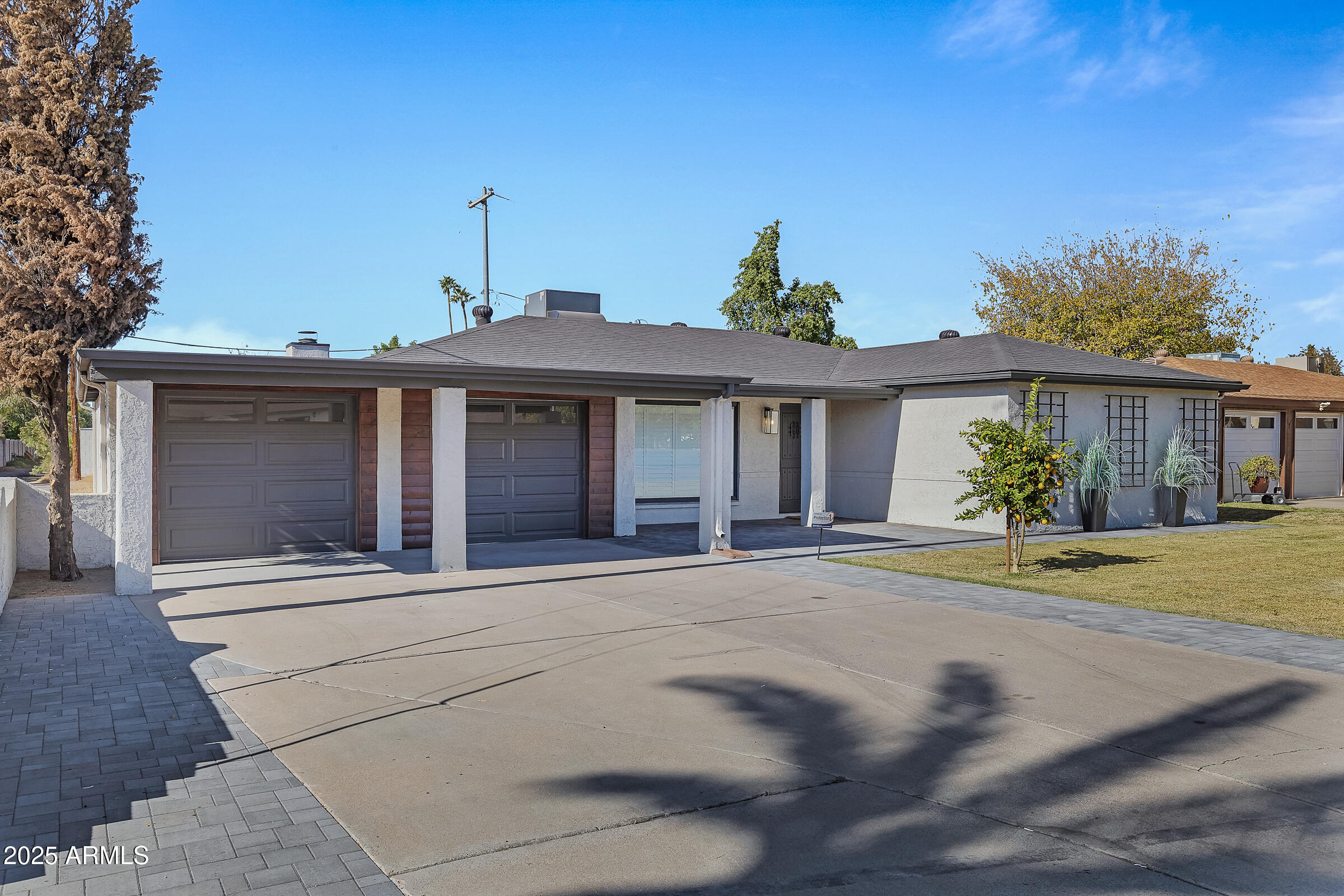 7308 North 7th Avenue Phoenix, AZ 85021 - Photo 3 of 42 a front view of a house with a yard and garage