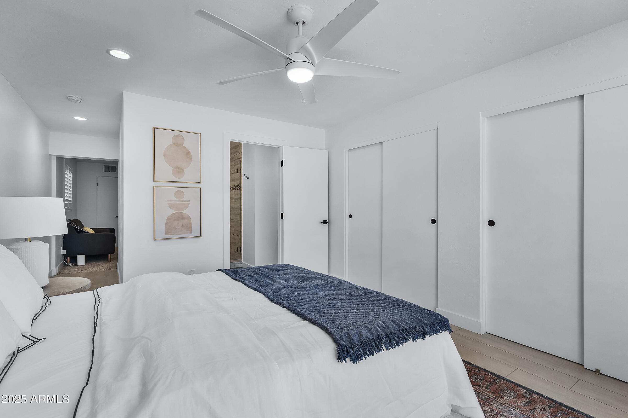 7308 North 7th Avenue Phoenix, AZ 85021 - Photo 32 of 42 a bedroom with a large bed a chandelier and closet