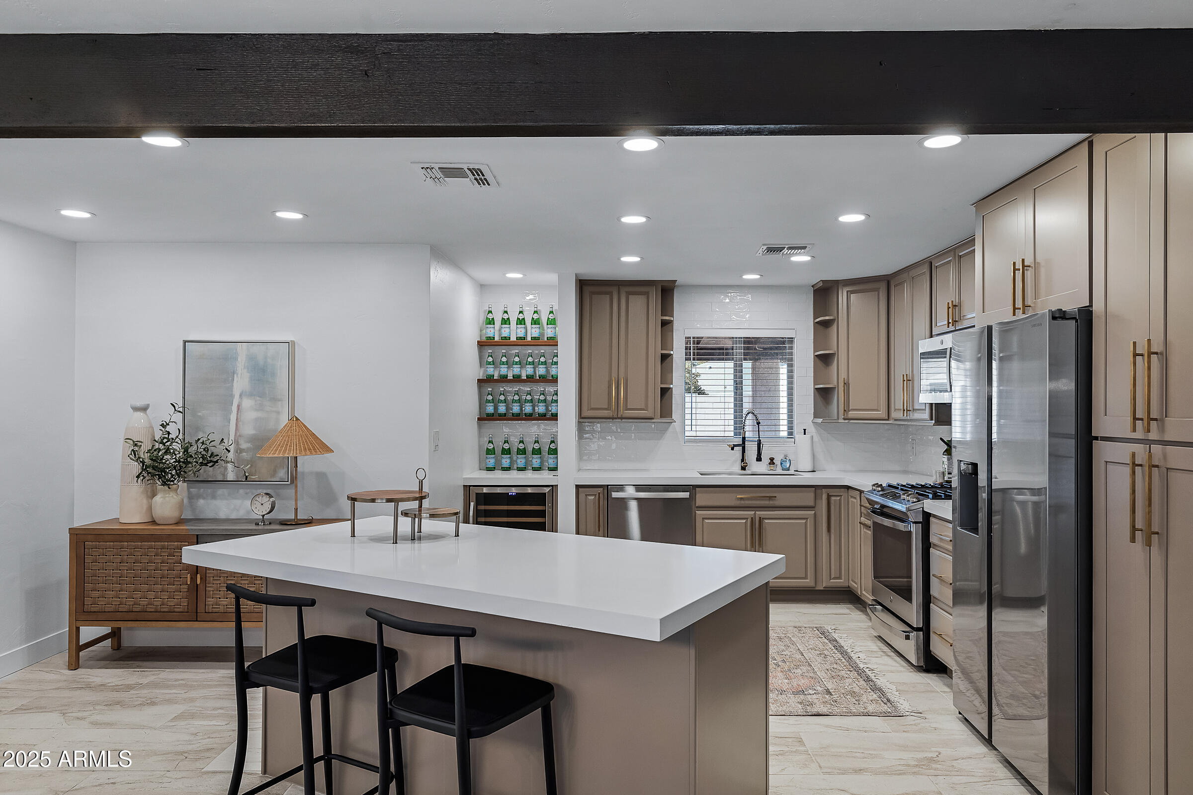 7308 North 7th Avenue Phoenix, AZ 85021 - Photo 9 of 42 a kitchen with stainless steel appliances kitchen island granite countertop a dining table chairs and refrigerator