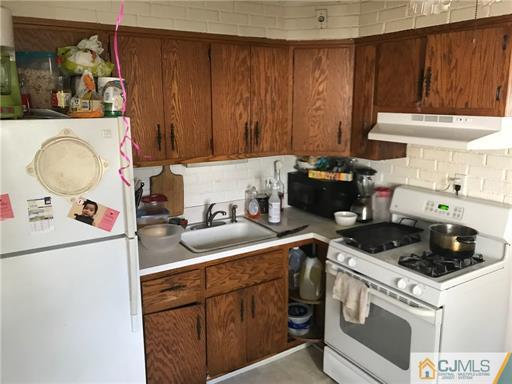 3 Brookville Road Edison, NJ 08817 - Photo 6 of 19 a kitchen with a sink stove and cabinets