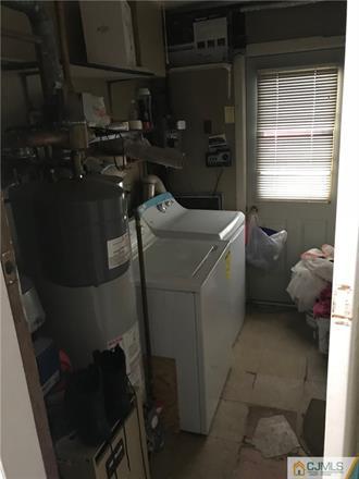 3 Brookville Road Edison, NJ 08817 - Photo 8 of 19 a room with water heater and wooden closet
