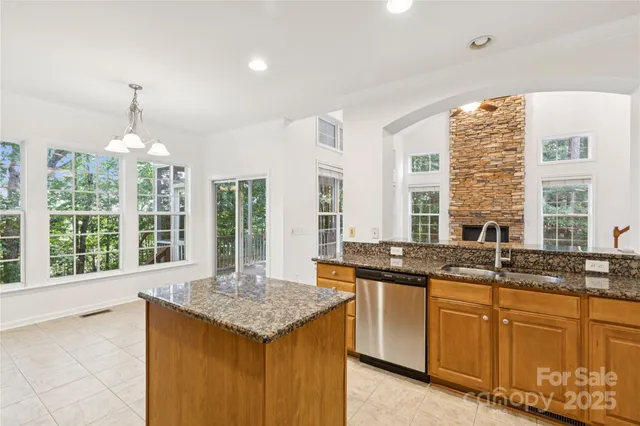 a kitchen with granite countertop a stove and a sink